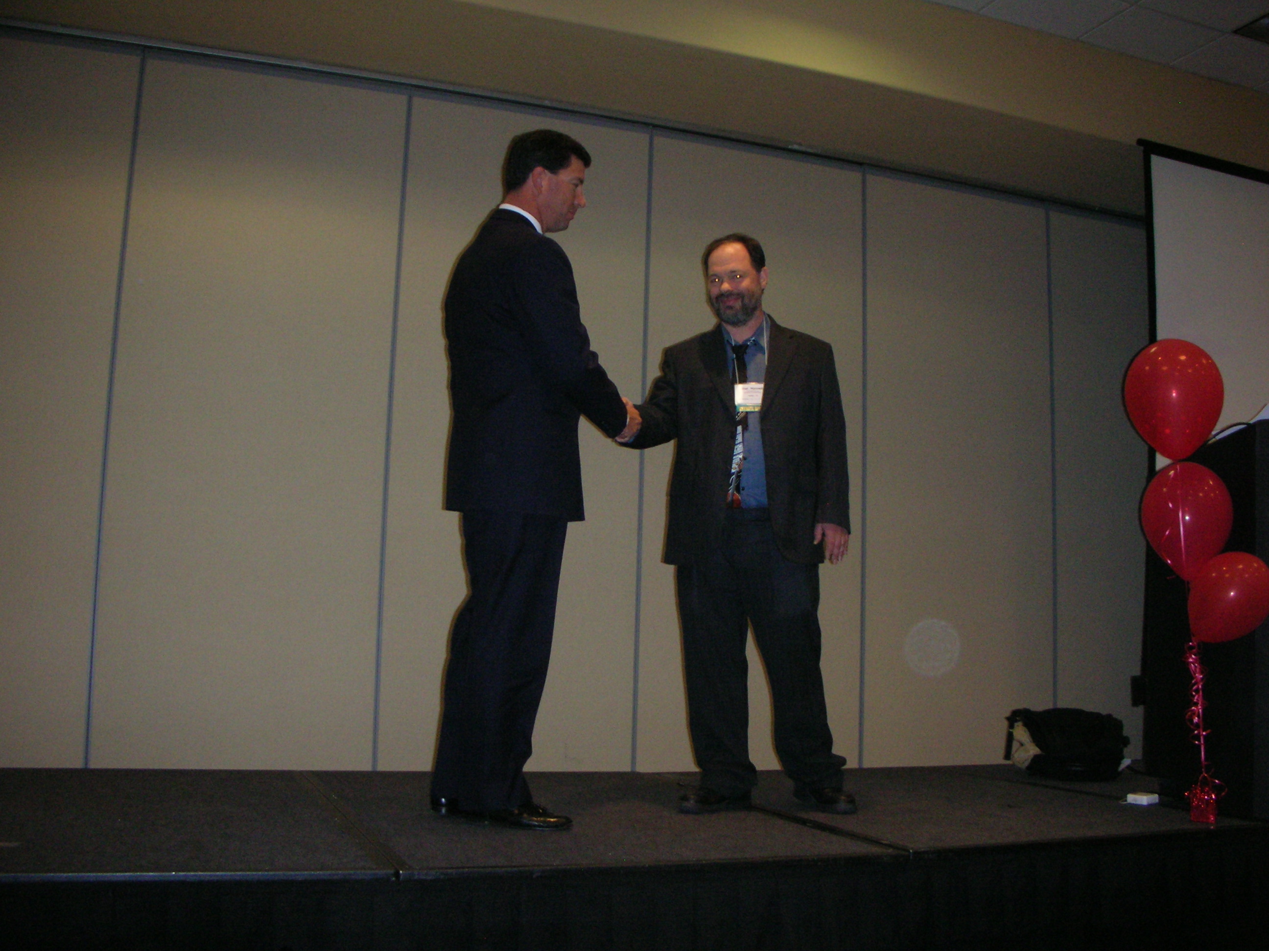 Jeff Armstrong (Left) greets Shel Horowitz at Noteworthy USA Convention